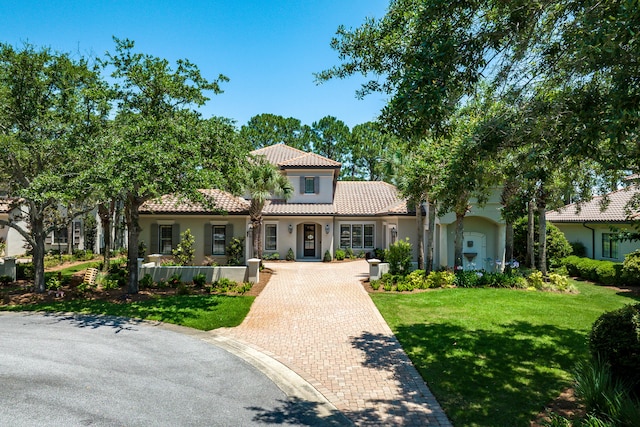 mediterranean / spanish house featuring a front yard