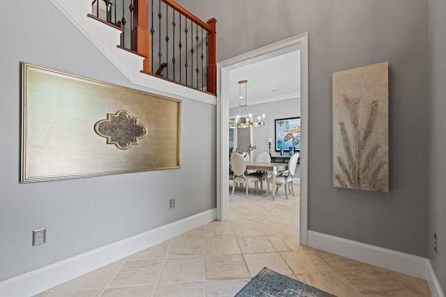 hall featuring a chandelier and ornamental molding