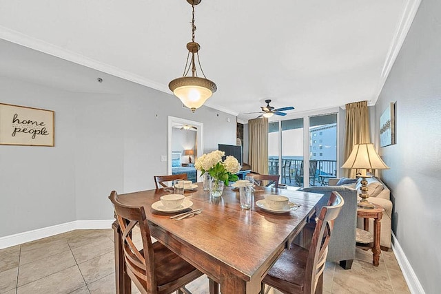 dining room featuring light tile patterned floors, a wall of windows, ornamental molding, and ceiling fan