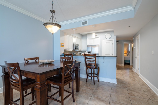 tiled dining space featuring ornamental molding