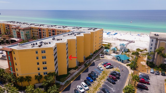 birds eye view of property featuring a beach view and a water view