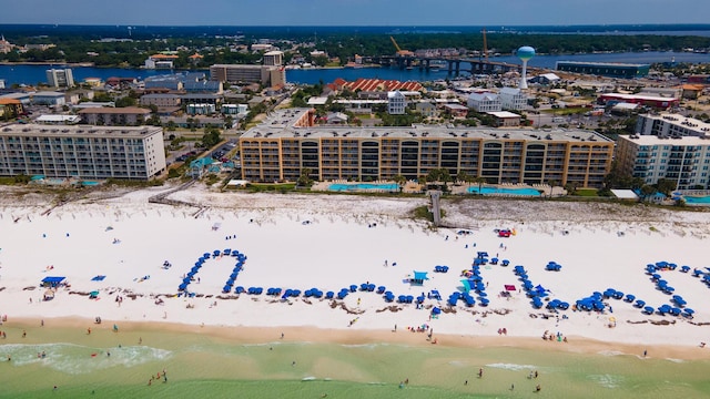 birds eye view of property featuring a beach view and a water view