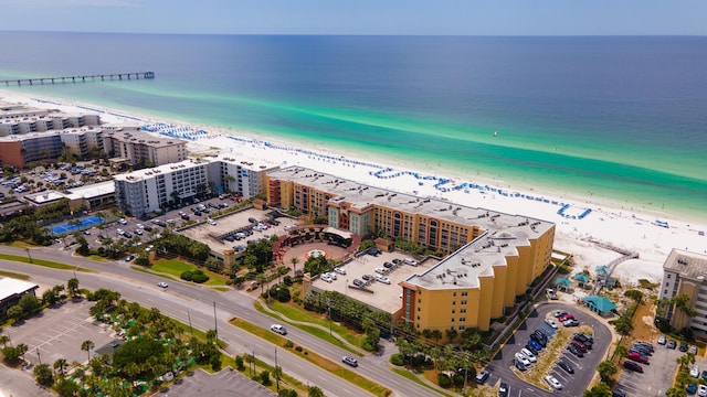 drone / aerial view with a water view and a beach view