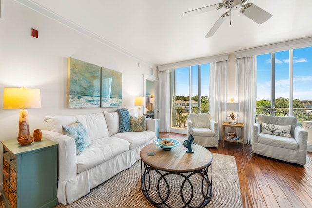 living room featuring a healthy amount of sunlight, crown molding, dark hardwood / wood-style floors, and ceiling fan