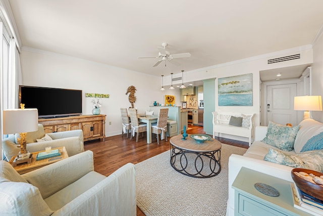 living room featuring ornamental molding, dark wood-type flooring, and ceiling fan