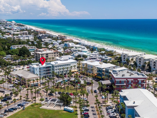 drone / aerial view with a beach view and a water view