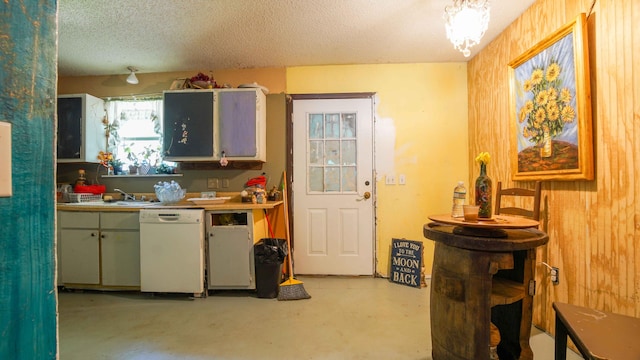 kitchen with sink, a textured ceiling, and white dishwasher