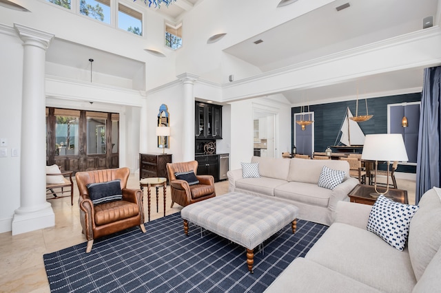 tiled living room with a high ceiling and decorative columns