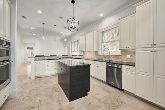 kitchen featuring tasteful backsplash, decorative light fixtures, a center island, sink, and appliances with stainless steel finishes