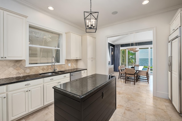 kitchen featuring sink, white cabinetry, tasteful backsplash, and pendant lighting