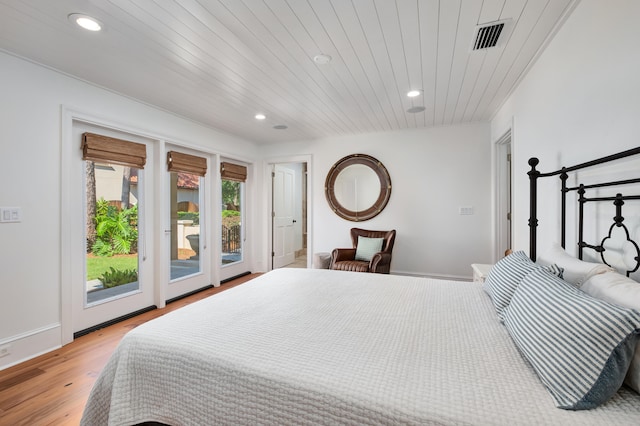 bedroom with wood ceiling, light wood-type flooring, and access to exterior