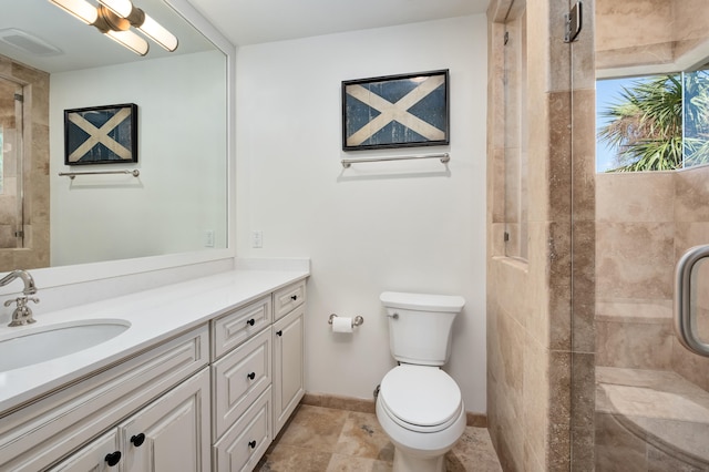 bathroom featuring tile floors, an enclosed shower, toilet, and vanity