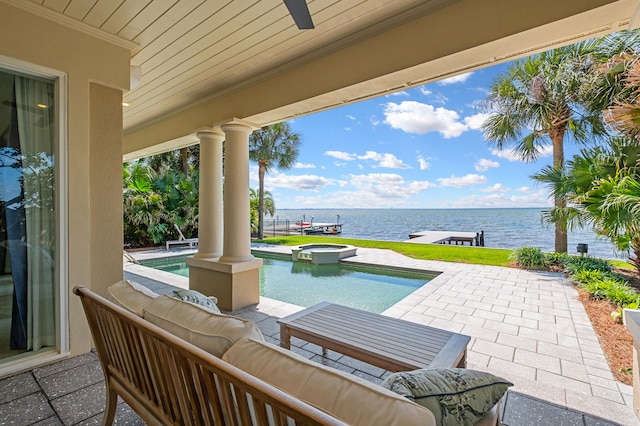 view of patio / terrace with an outdoor hangout area, a pool with hot tub, and a water view