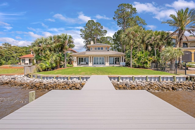 view of dock with a lawn