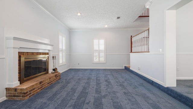 unfurnished living room with dark colored carpet, ornamental molding, a textured ceiling, and a fireplace