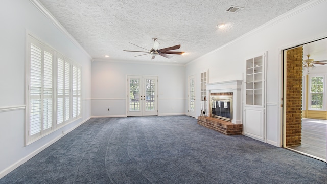 unfurnished living room featuring ornamental molding, ceiling fan, and dark carpet