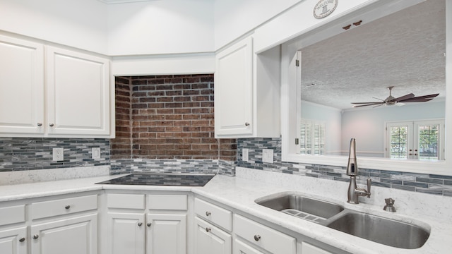 kitchen featuring white cabinetry, a textured ceiling, sink, and ceiling fan