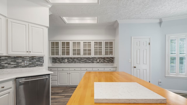 kitchen with tasteful backsplash, stainless steel dishwasher, a textured ceiling, wood counters, and ornamental molding