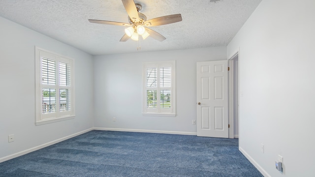 unfurnished room featuring carpet flooring, ceiling fan, a textured ceiling, and a healthy amount of sunlight