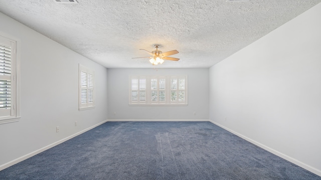 carpeted spare room featuring ceiling fan and a textured ceiling