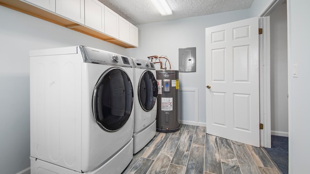 laundry room featuring separate washer and dryer, a textured ceiling, electric water heater, and wood-type flooring