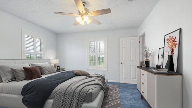 carpeted bedroom with multiple windows, a textured ceiling, and ceiling fan