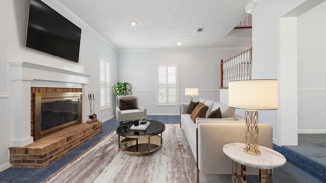 carpeted living room with ornamental molding, a textured ceiling, and a fireplace