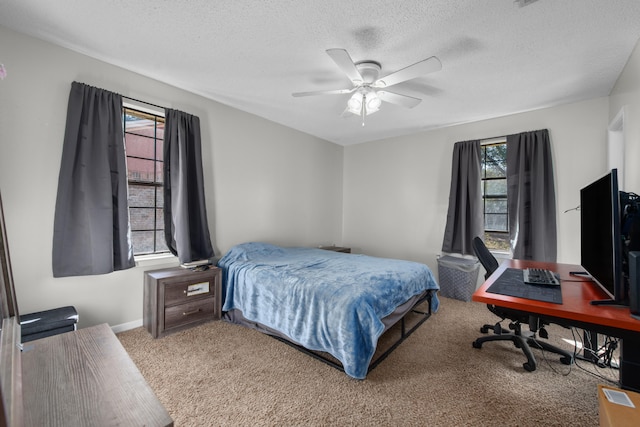 carpeted bedroom with a textured ceiling and ceiling fan