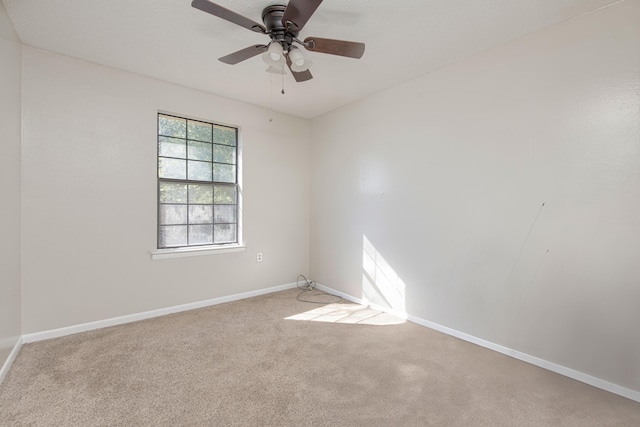 empty room featuring carpet and ceiling fan