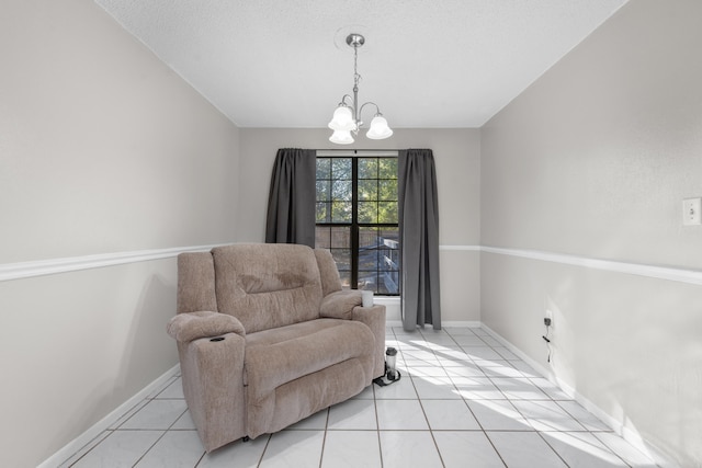 living area featuring a chandelier and light tile floors