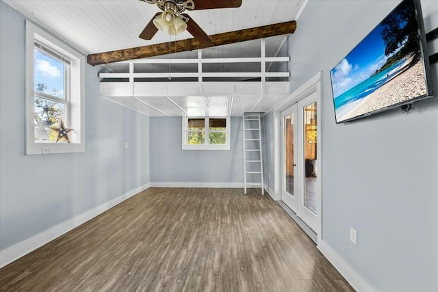 spare room featuring hardwood / wood-style floors, vaulted ceiling with beams, ceiling fan, and french doors