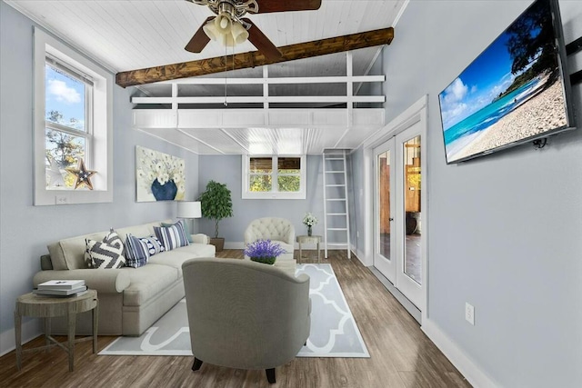 interior space with french doors, lofted ceiling with beams, ceiling fan, and a healthy amount of sunlight