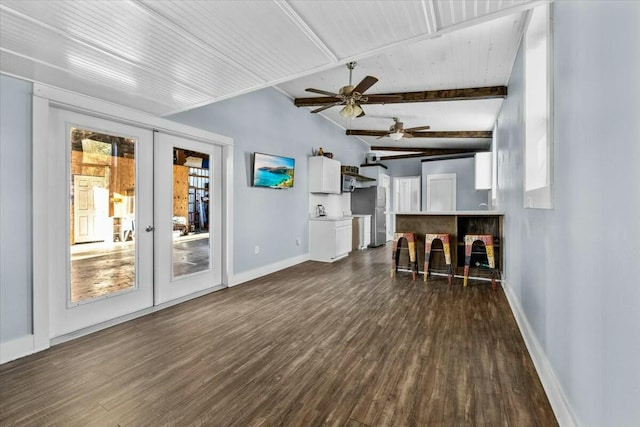 living room with dark hardwood / wood-style flooring, ceiling fan, french doors, and vaulted ceiling with beams