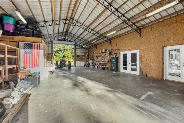 garage featuring a workshop area and french doors