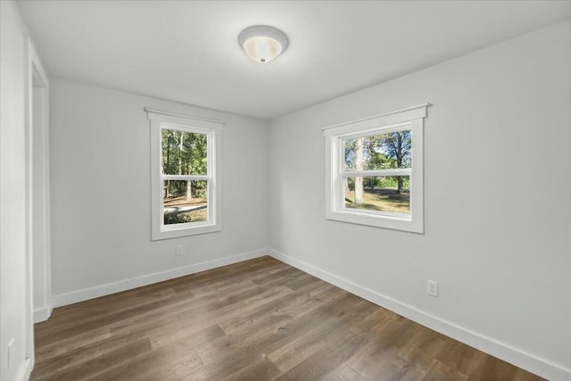 empty room with hardwood / wood-style flooring