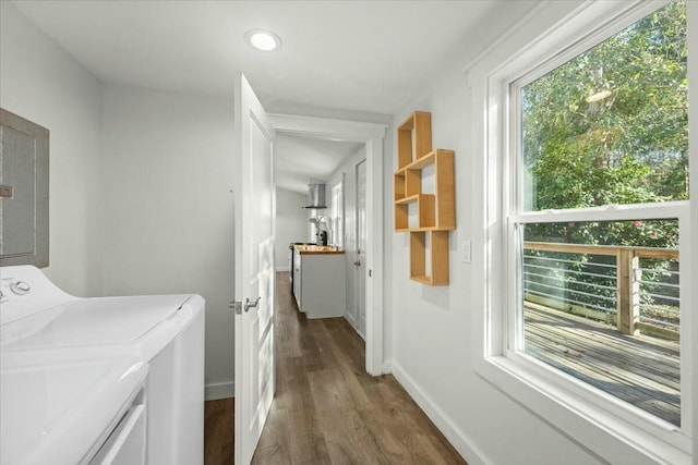 laundry area with dark hardwood / wood-style flooring, electric panel, and washing machine and clothes dryer