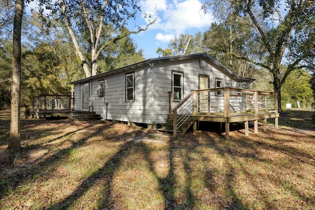 view of property exterior featuring a wooden deck