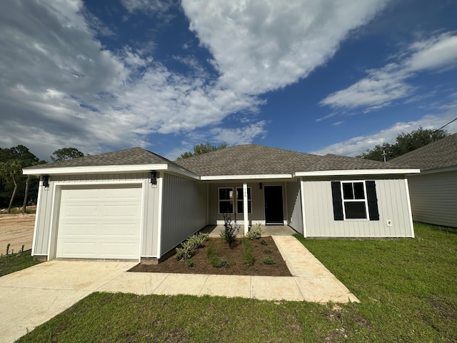 ranch-style house featuring a porch, a front yard, and a garage