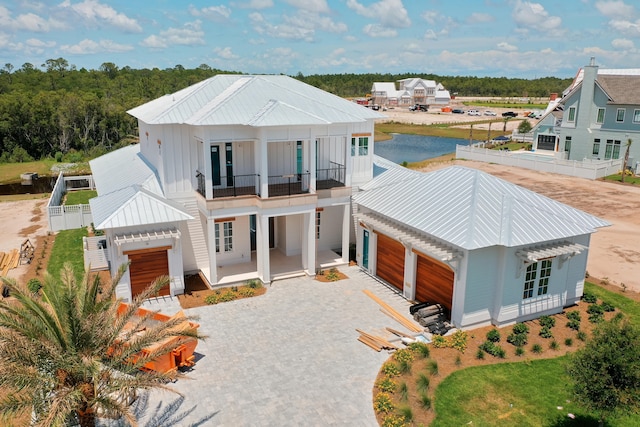 modern inspired farmhouse featuring a garage and a balcony