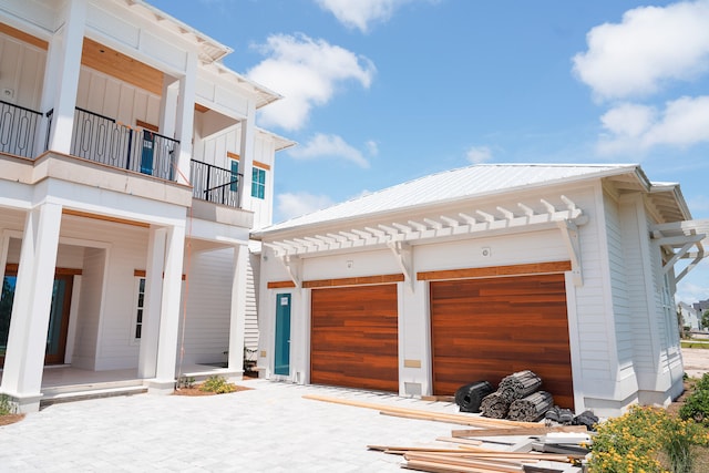 view of front of property with a garage and a balcony