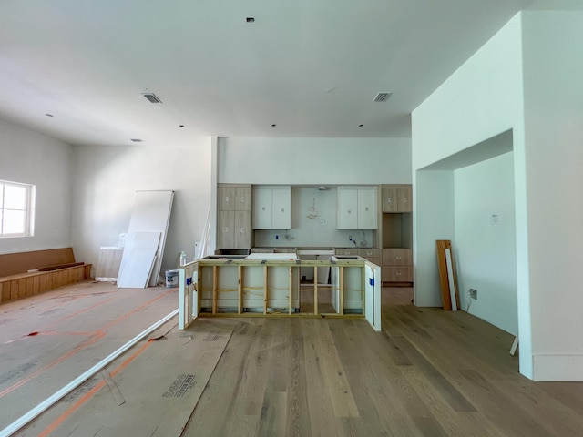 kitchen featuring white cabinetry and light hardwood / wood-style floors