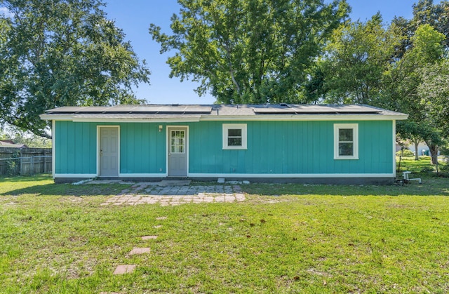 rear view of house with a yard