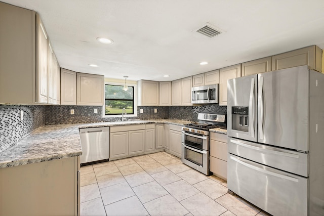 kitchen with light tile patterned floors, backsplash, stainless steel appliances, and sink