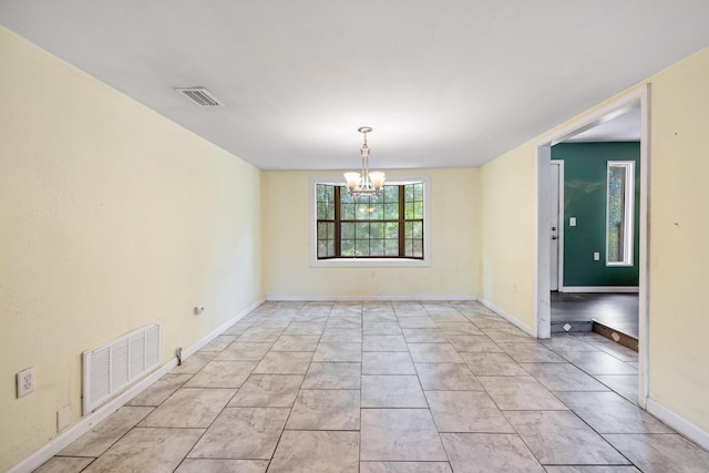 unfurnished room featuring light tile patterned floors and a notable chandelier