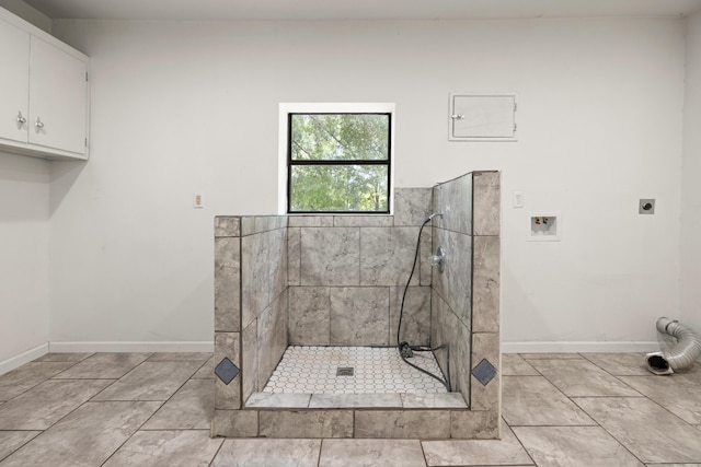 bathroom featuring tile patterned floors and tiled shower