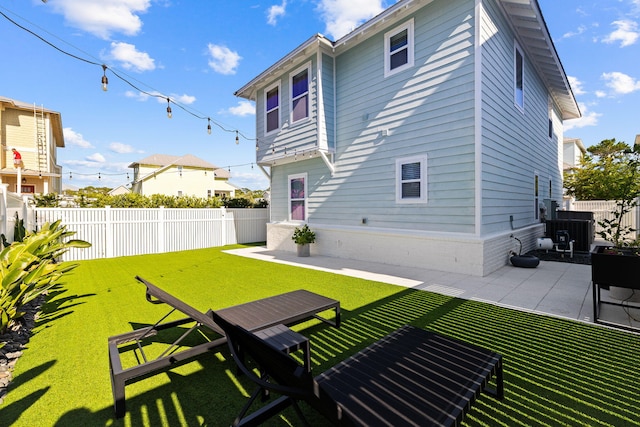 rear view of property with a patio area and a lawn