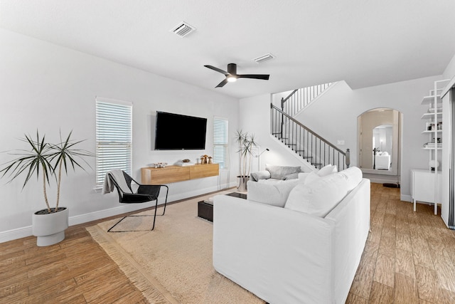 living room featuring wood-type flooring and ceiling fan