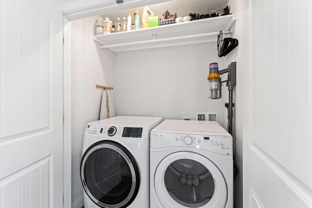 clothes washing area featuring washer and dryer and washer hookup