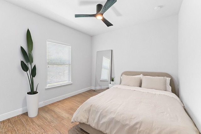 bedroom with ceiling fan and light hardwood / wood-style floors