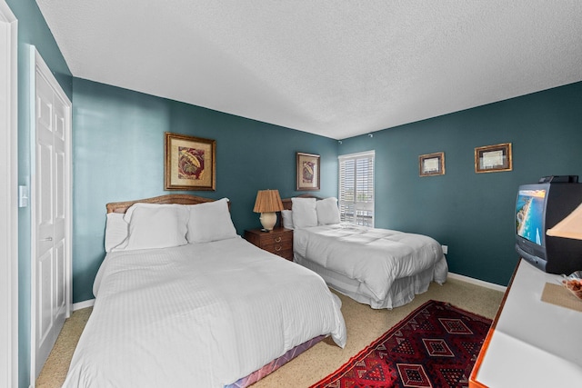 bedroom with carpet flooring and a textured ceiling